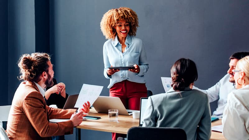 Woman using soft skills to lead team meeting in financial services